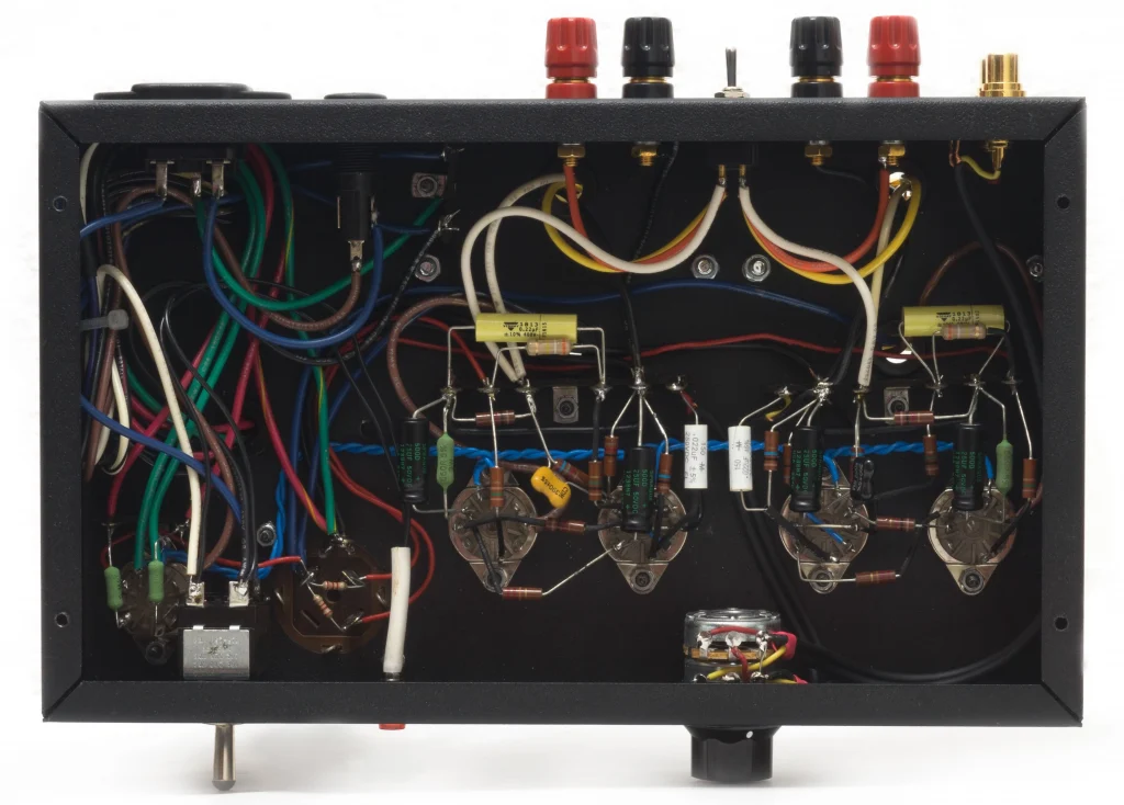 Underside view of the 1955-1 tube amplifier showing point-to-point wiring inside the chassis