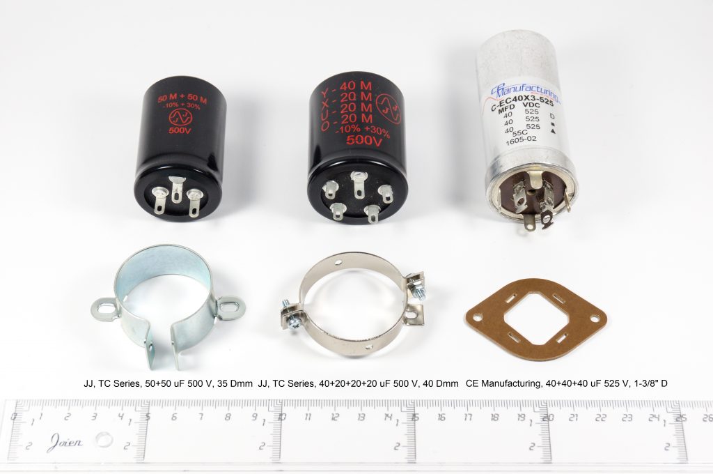 Multi-section can electrolytic capacitors and mounting hardware for the amplifier power supply.